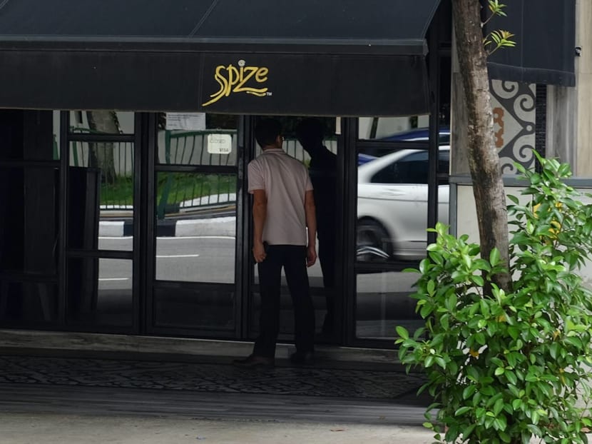 An onlooker looks into the shuttered Spize outlet at River Valley on Friday, December 7, 2018. It will have its licence terminated immediately, after a joint investigation by the NEA, AVA and MOH found several hygiene lapses, including unlicensed food handlers, and poor personal hygiene from food handlers.