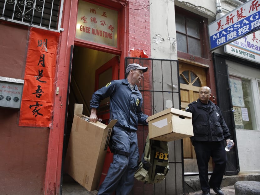 An FBI agent carries out boxes of evidence following a search of a Chinatown fraternal organisation in San Francisco. Raymond Chow, nicknamed "Shrimp Boy" who insisted he had changed his ways but was hounded by federal investigators is set to be sentenced to life in prison following his conviction on racketeering and murder. Photo: AP