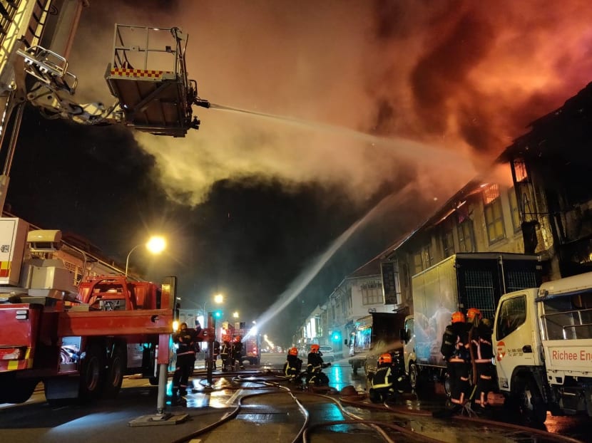 Firefighters arrived at the scene to find the raging fire spreading to a row of double-storey shophouses.