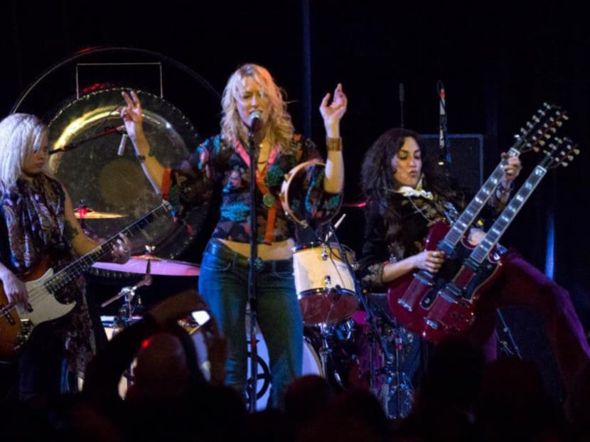 Steph Paynes (right) and the girls of Lez Zeppelin rocking out on stage.