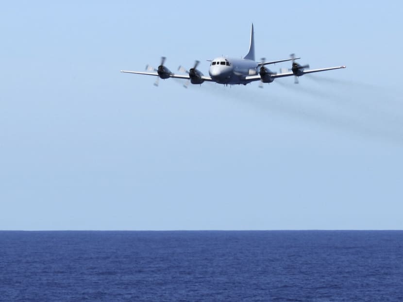 In this April 7, 2014, photo provided by the Australian Defence Force a Royal Australian Air Force AP-3C Orion conducts a low level fly-by before dropping stores to HMAS Toowoomba in the southern Indian Ocean during the search for the missing Malaysia Airlines flight MH370. Photo: AP