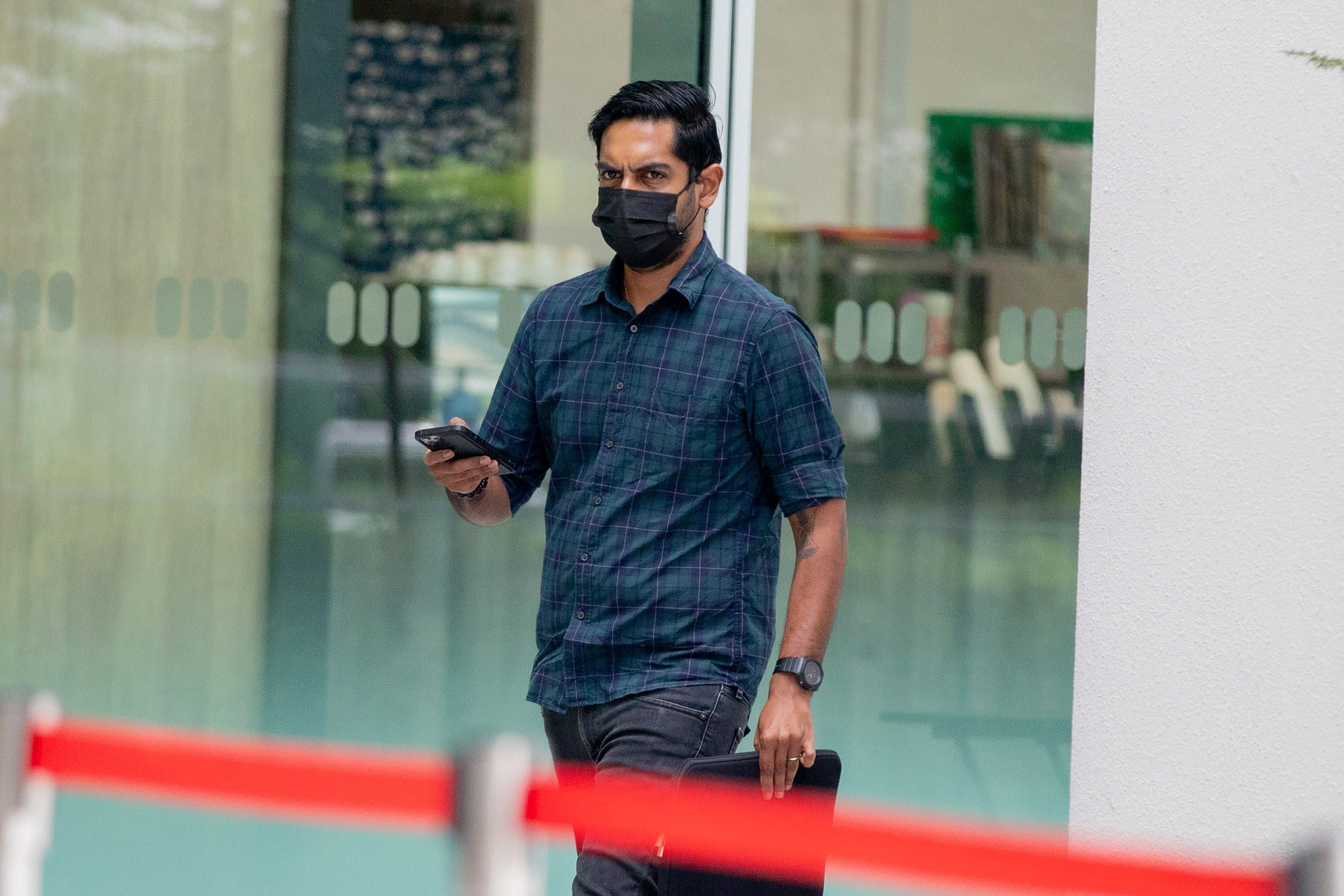 Sanjiv Kumar Sivaraj arriving at the State Courts on Jan 26, 2022. The 32-year-old was fined S$3,000 for verbally abusing a police officer.