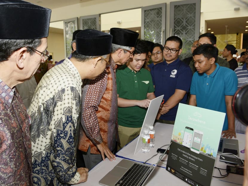Dr Yaacob (third from left) with Terawhere app developers yesterday. The free carpooling app, which will be launched on Friday, will not only help save the environment but also build communities, he said Photo: MUIS