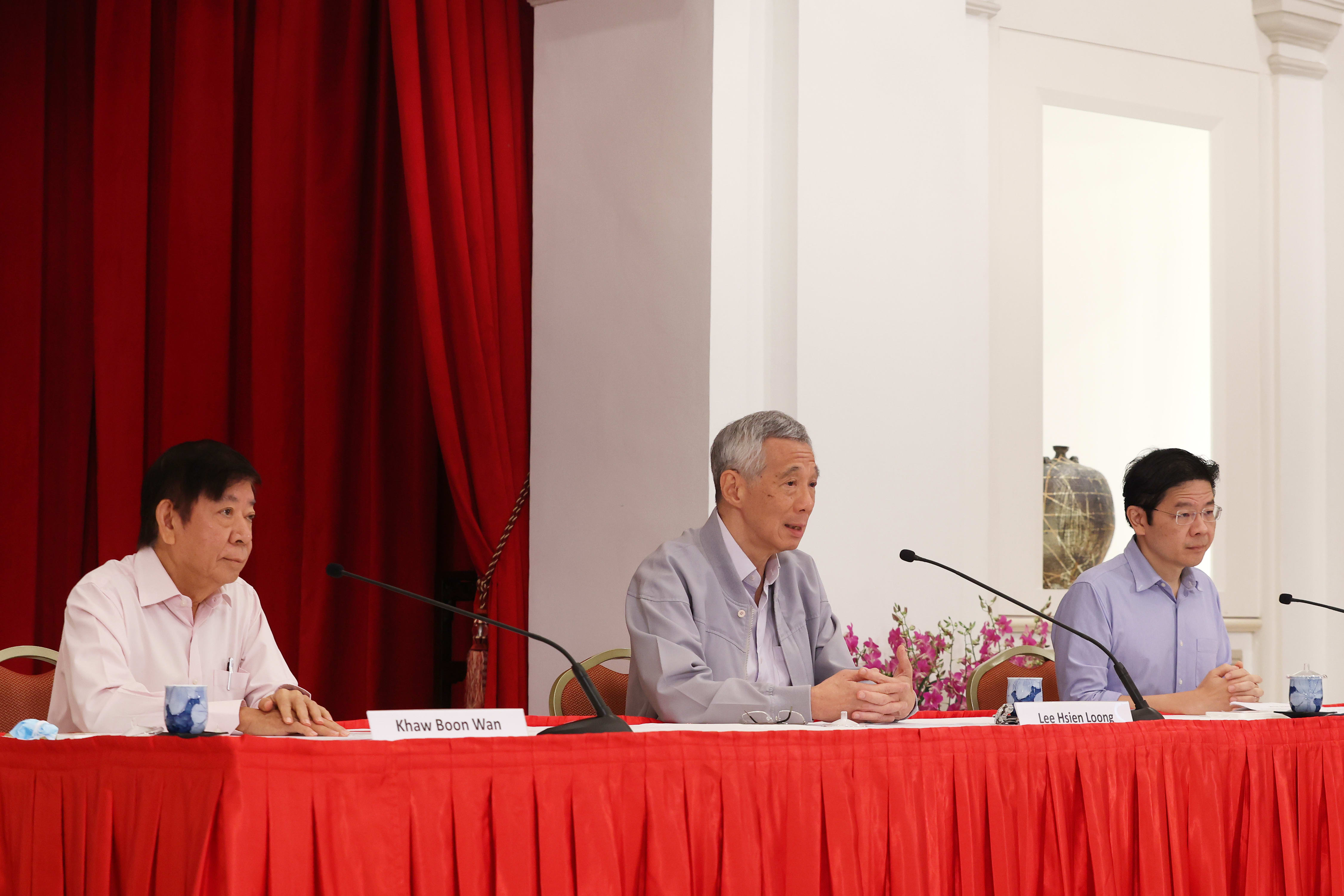 Prime Minister Lee Hsien Loong (centre) held a press conference together with former minister Khaw Boon Wan (left) and Finance Minister Lawrence Wong on April 16, 2022. 