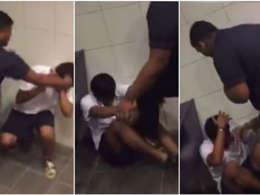 The 75-second clip showed a student, clad in black, kicking and raining blows on a smaller-built student in a corner of the toilet. Screengrab: Soniya Raj/Facebook