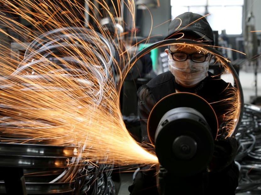 FILE PHOTO: A worker welds a bicycle steel rim at a factory manufacturing sports equipment in Hangzhou, Zhejiang province, China September 2, 2019. China Daily via REUTERS