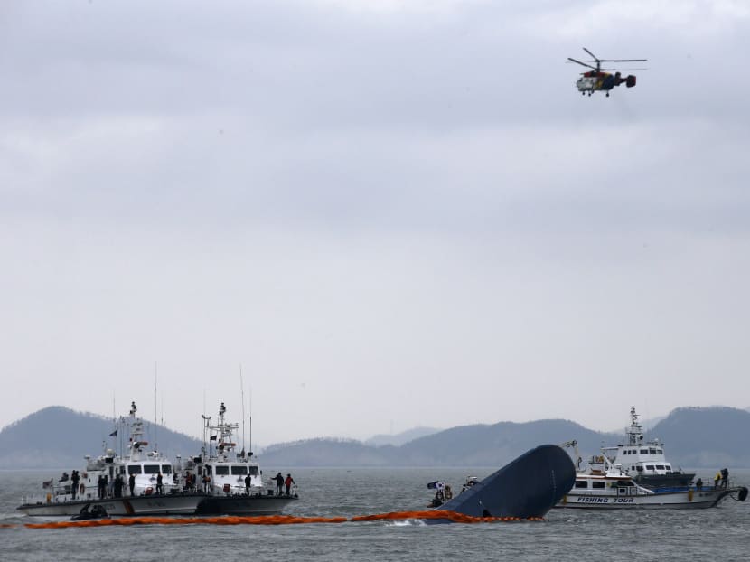 Rescue ships and a helicopter take part in a rescue operation around South Korean passenger ship Sewol, which sank in the sea off Jindo, on April 17, 2014.