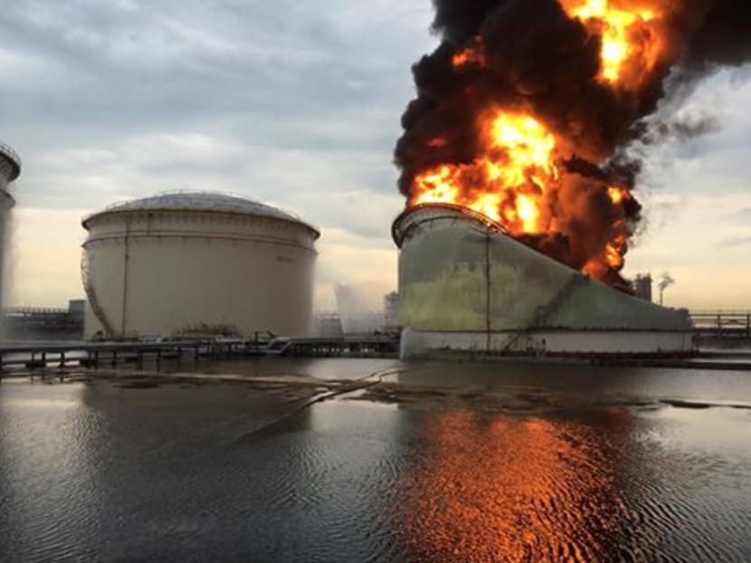 A fire at an oil tank on Jurong Island on April 20, 2016 blazed for five hours with an intensity that led it to 'fold and buckle'. Photo: Singapore Civil Defence Force/Facebook
