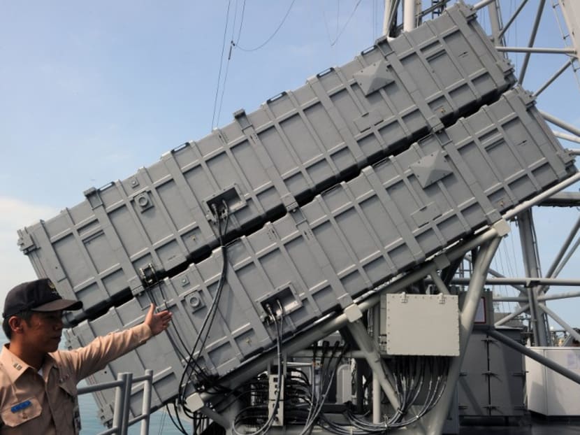 A Taiwanese naval officer points to launchers of locally-developed supersonic Hsiungfeng III (Brave Wind III) ship-to-ship missiles installed on a Perry-class frigate. AFP file photo