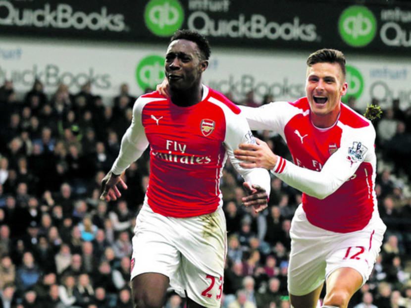Arsenal have won nine of their last 10 matches and Liverpool will have to watch out for Danny Welbeck (left) and Olivier Giroud. Photo: Reuters