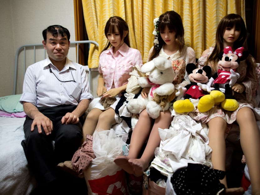 Physiotherapist Masayuki Ozaki poses with his silicone sex dolls at his bedroom in Tokyo. Photo: AFP