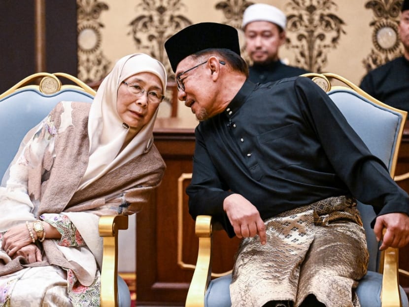 Malaysia's newly appointed Prime Minister Anwar Ibrahim and his wife Wan Azizah Wan Ismail taking part in the swearing-in ceremony at the National Palace in Kuala Lumpur on Nov 24, 2022.
