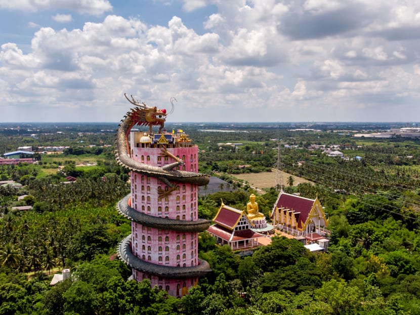 This aerial file photo taken on Sept 11, 2020 shows the Buddhist temple Wat Samphran (Dragon Temple) in Nakhon Pathom, some 40km west of Bangkok. A dragon encircles a tower, wretched souls face torture, superheroes scale a mosiac wall — these may seem like scenes from a half-remembered dream, but are in fact famed temples in Thailand. This aerial file photo taken on Sept 11, 2020 shows the Buddhist temple Wat Samphran (Dragon Temple) in Nakhon Pathom, some 40km west of Bangkok. A dragon encircles a tower, wretched souls face torture, superheroes scale a mosiac wall — these may seem like scenes from a half-remembered dream, but are in fact famed temples in Thailand.