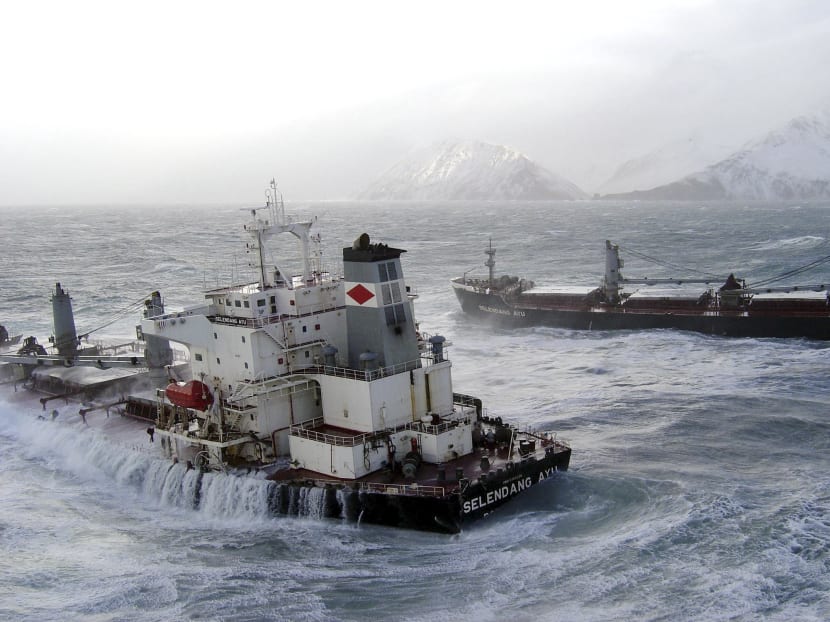 The 738-foot Malaysian cargo ship Selendang Ayu, split in two in high seas and gale-force winds, sits offshore of Skan Bay on Unalaska Island near Unalaska, Alaska, in the Aleutian Island chain, Dec 11, 2004. Photo: The New York Times