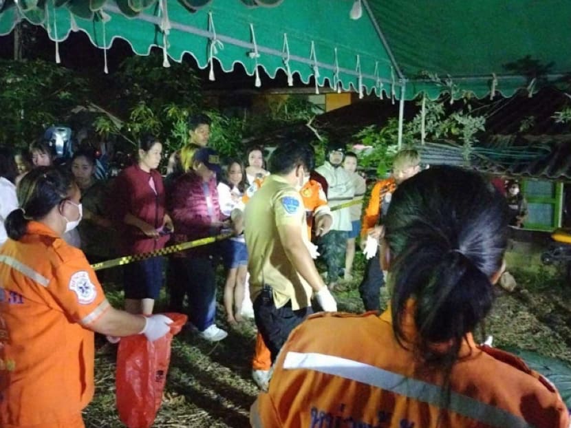Rescue workers examine the scene of a shooting at a wedding party at a house in Wang Nam Khieo district, Nakhon Ratchasima, on Nov 25, 2023.