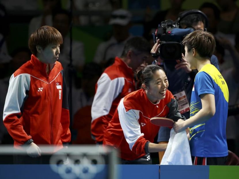 Singapore's Zhou Yihan (left), Yu Mengyu (centre) and Feng Tianwei celebrating their win over South Korea. Photo: Reuters