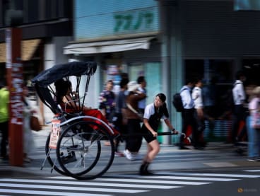 Rickshaw puller Akina Suzuki, 19, drives a rickshaw around Asakusa district in Tokyo, Japan, on June 18, 2023.      