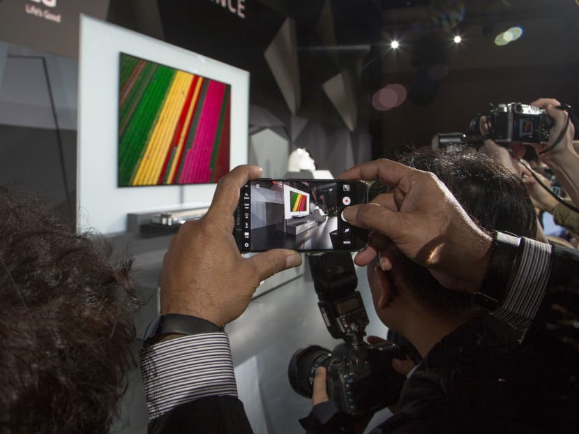 People photograph the LG Signature OLED TV W at the LG press conference at the 2017 Consumer Electronics Show (CES) in Las Vegas, Nevada on Jan 4, 2017.  Photo: AFP