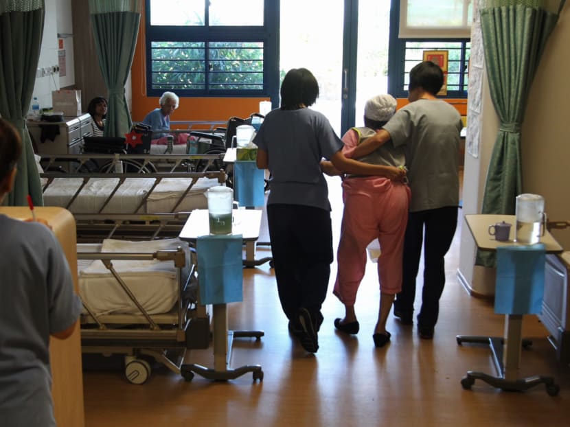 A patient receiving help from nurses at the new Dementia Care Ward at St. Andrew's Community Hospital located at Simei Street.