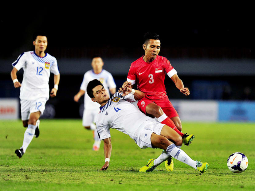 Singapore against Laos (in white). On Monday, the Asian Football Confederation suspended four players from the Laos national team on suspicion of match manipulation. Photo: Singapore Sports Council