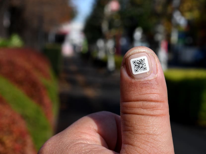 This picture taken on December 5, 2016 shows a city officer displaying a QR code on his fingernail near the Iruma city hall in Iruma, Saitama prefecture, a western suburb of Tokyo. Photo: AFP