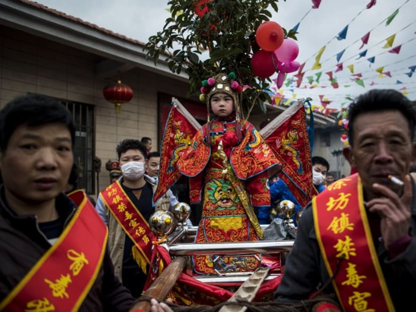 Locals carrying children in palanquins during the annual festival in China's Tufang village that commemorates the end of barbaric child sacrifices hundreds of years ago. Photo: AFP