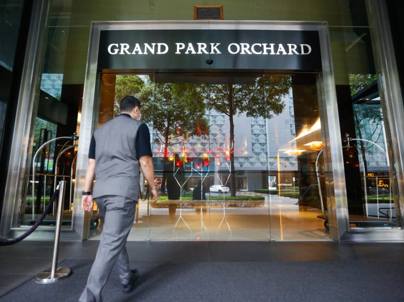 A hotel employee walks into Grand Park Orchard. The hotel is among several where students returning home from overseas have booked in or are checking in to serve their 14-day stay-home notice.