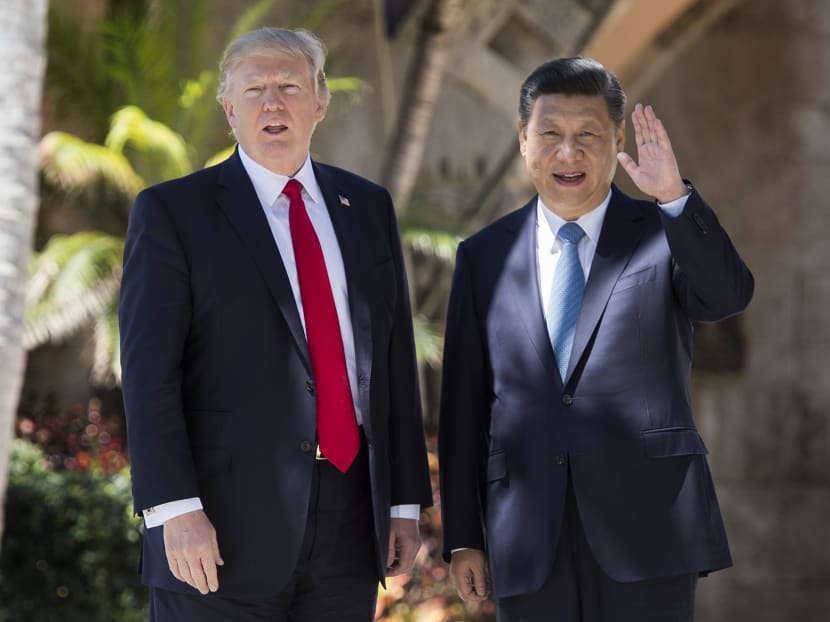 Chinese President Xi Jinping (R) waves to the press as he walks with US President Donald Trump at the Mar-a-Lago estate in West Palm Beach, Florida, April 7, 2017.  Photo: AFP