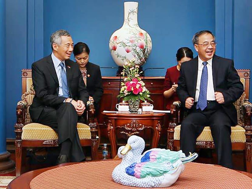 Prime Minister Lee Hsien Loong (left) sharing a laugh with Guangdong Party Secretary Hu Chunhua during a meeting at the Guangdong Government House in China. PHOTO: Ministry of Communications and Information