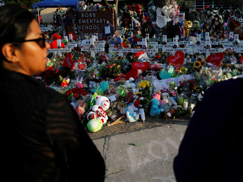 People pay their respects at the Robb Elementary School memorial, where a gunman killed 19 children and two teachers in the deadliest U.S. school shooting in nearly a decade, in Uvalde, Texas, on May 30, 2022.
People pay their respects at the Robb Elementary School memorial, where a gunman killed 19 children and two teachers in the deadliest U.S. school shooting in nearly a decade, in Uvalde, Texas, on May 30, 2022.