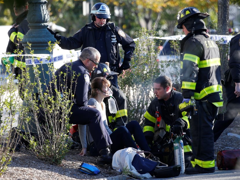 A woman is aided by first responders after sustaining injury on a bike path in lower Manhattan in New York. Photo: Reuters