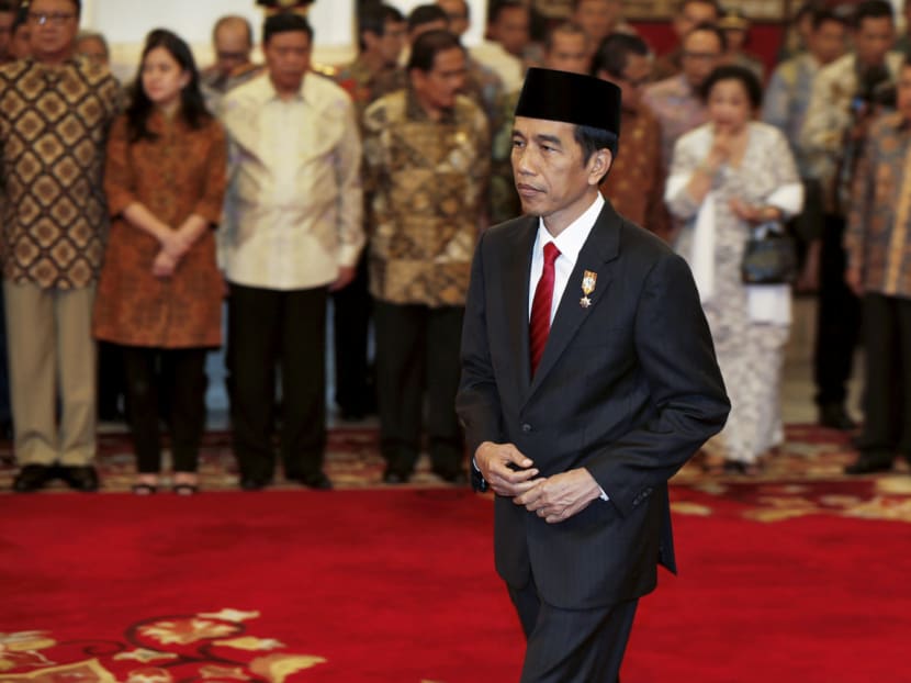 President Joko Widodo after the swearing-in of Basuki Tjahaja Purnama as Jakarta Governor at the Presidential palace in Jakarta in 2014. Many observers perceive the President’s silence on the Governor’s trial as a case of throwing his political ally to the wolves. Photo: Reuters