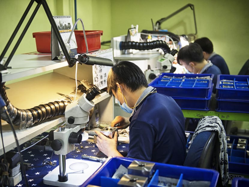 Employees work at a manufacturing facility in Singapore. Bloomberg file photo