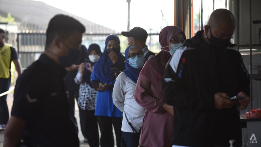 Johor state election: Voters cast their ballots on polling day amid tight COVID-19 protocols 