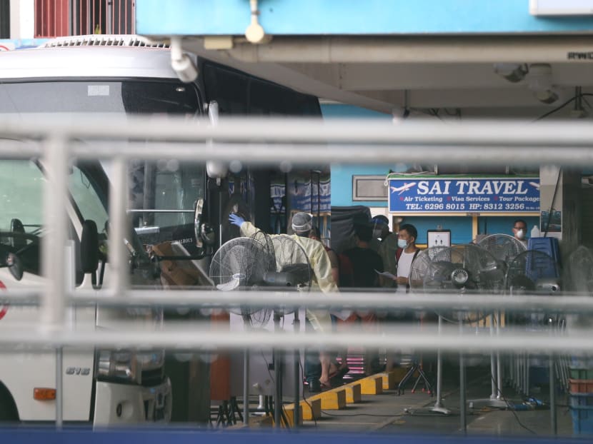 Foreign workers staying at Westlite Woodlands dormitory boarding a bus that will transport them to a government quarantine facility on April 22, 2021. Foreign workers staying at Westlite Woodlands dormitory boarding a bus that will transport them to a government quarantine facility on April 22, 2021.