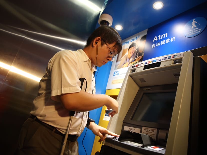 A user activates the voice instruction feature by plugging his headset into the ATM’s audio jack. Photo: Don Wong/TODAY