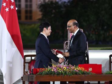 President Tharman Shanmugaratnam (right) shaking hands with newly sworn-in Prime Minister Lawrence Wong as he presented Mr Wong with the Instrument of Appointment, at the Istana on May 15, 2024. 