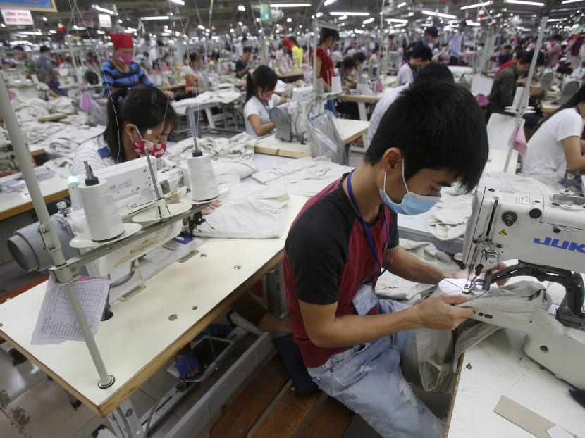 A garment factory in Bac Giang province, near Hanoi, Vietnam. Singapore investors are focusing on Vietnam in the area of manufacturing, particularly textiles. Reuters file photo