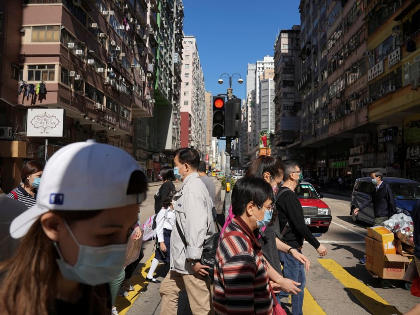 People wearing face masks to prevent the spread of the coronavirus disease (COVID-19), walk on a street in Hong Kong. Photo: Reuters