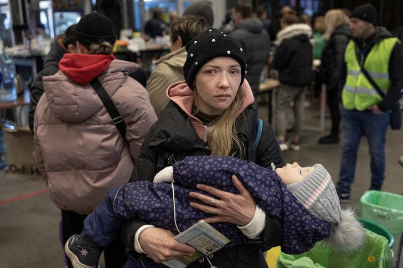 A woman cries as she holds her baby after they have arrived with other evacuees from Mariupol, as Russia's invasion of Ukraine continues, in Zaporizhzhia, Ukraine, March 29, 2022. A woman cries as she holds her baby after they have arrived with other evacuees from Mariupol, as Russia's invasion of Ukraine continues, in Zaporizhzhia, Ukraine, March 29, 2022.