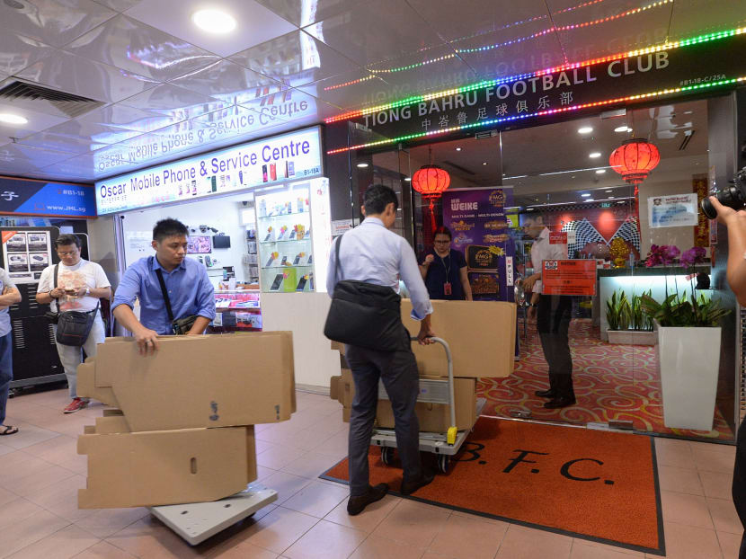 Investigators arriving with carton boxes and push trolleys at Tiong Bahru Football Club clubhouse at People's Park Centre. Photo: Robin Choo/TODAY