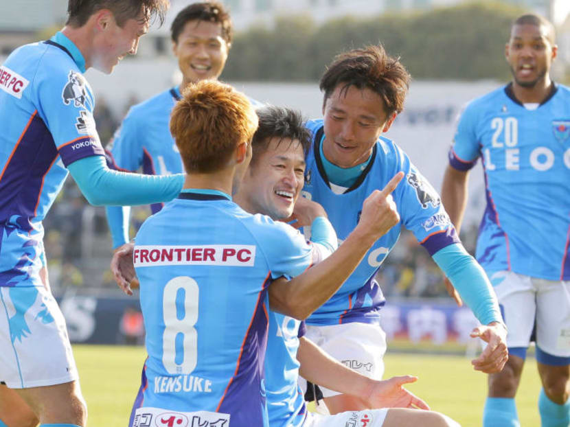 Kazuyoshi Miura (centre) celebrating withi his Yokohama FC teammates after scoring his first goal of the season during a J-League match against Thespa Kusatsu. Photo: AP