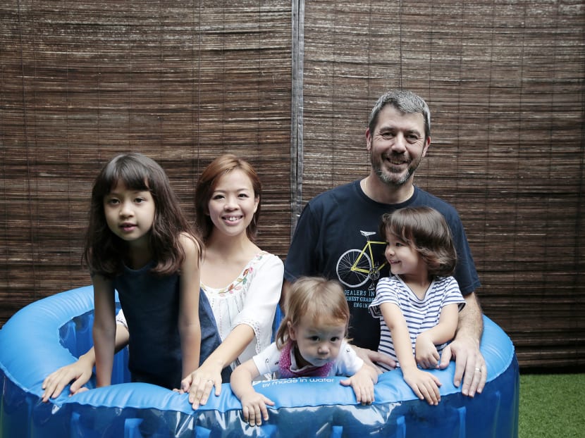 Ms Diana Chen, her husband Ashley Robinson and their children (L-R) Jemimah, 9, Samuel, 16 months, and Matilda, 4, pose for a photo in the inflatable birthing tub that Diana used. Photo: Jason Quah/TODAY