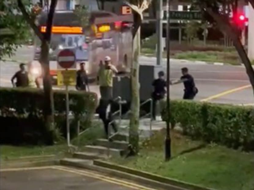 A screengrab from the video clip, showing the moment when the metal bar-wielding man, as he was walking up the steps, was tasered by the police.
