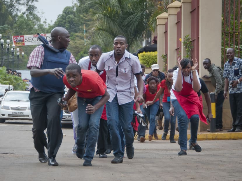 Civilians who had been hiding inside during gunbattles manage to flee from the Westgate Mall in Nairobi, Kenya Saturday, Sept. 21, 2013. Photo: AP