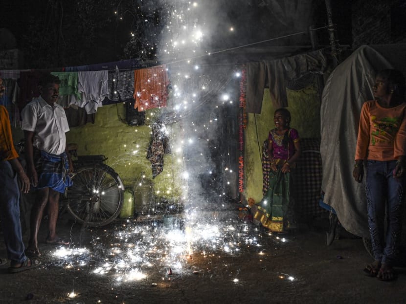 In this file photo taken on Nov 14, 2020, revellers light firecrackers during Deepavali, the Hindu Festival of Lights, in New Delhi.