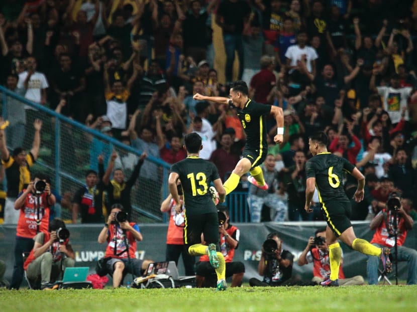 Malaysia's Azam Azih leaping into the air after scoring his spectacular equaliser against Singapore. Malaysia scored again five minutes later to effectively end Singapore's hopes of reaching the semi-finals. Photo: Jason Quah/TODAY