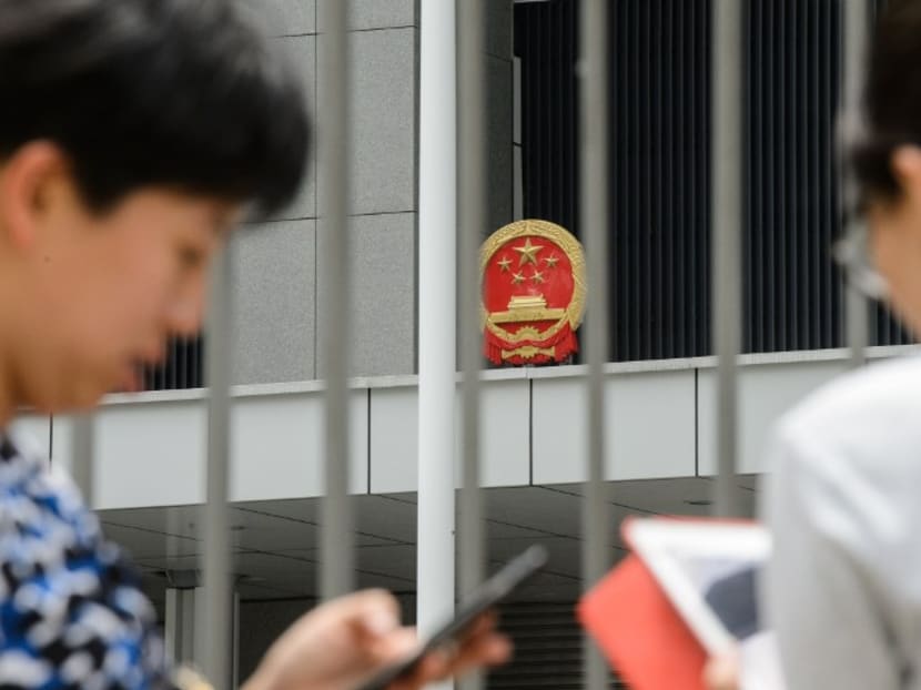 People use their phones to play the Pokemon Go app outside the Legislative Council offices in Hong Kong on July 26, 2016. Photo: AFP
