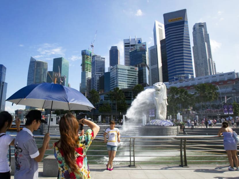 Tourists at Merlion Park. The current growth in visitor arrivals is unlikely to offset the increase in room supply within the short to medium term. Photo: Reuters