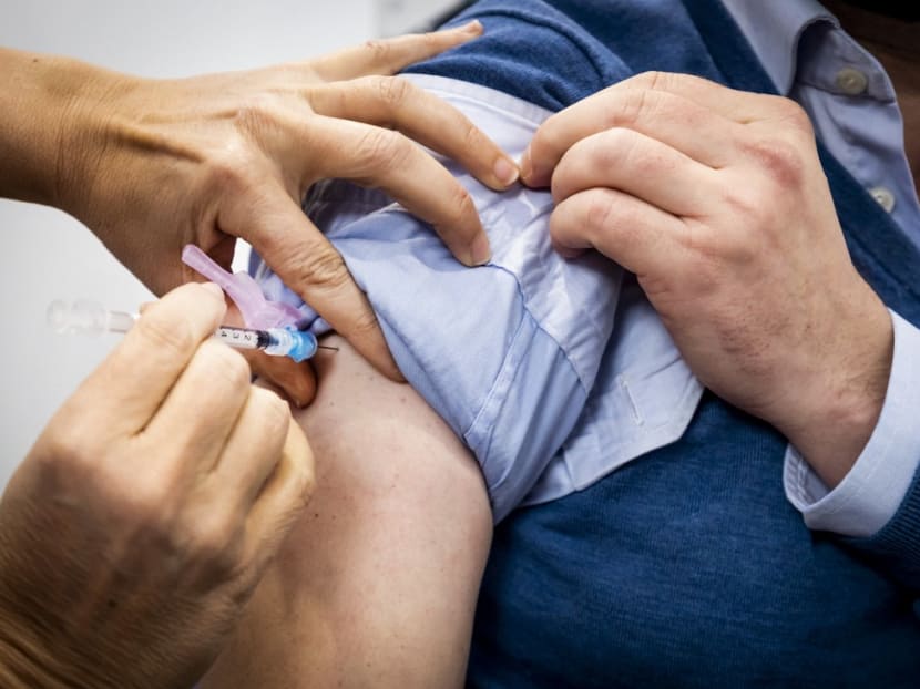 A member of the public receives a jab at a Covid-19 vaccination centre set up in Schiphol Sirport in Schiphol, near Amsterdam, on Jan 6, 2022, amid the Covid-19 pandemic.<br />
&nbsp;